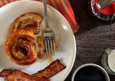 Custom food styling photography. Cinnamon roll french toast & bacon.